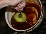 dipping apples into vegan carmel